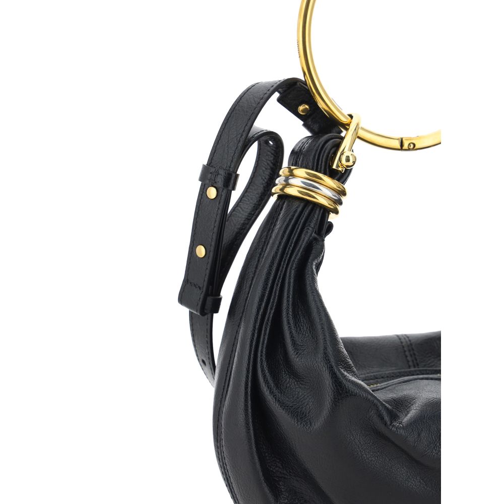 Black Calf Leather Bos Taurus HandbagLeather Bracelet Handbag by Chloé, a round brass handle, an adjustable flat shoulder strap and removable top zipper closure, single interior compartment. Season: AW25 Dimension: 32x32x10 Composition: 100% Calf Leather