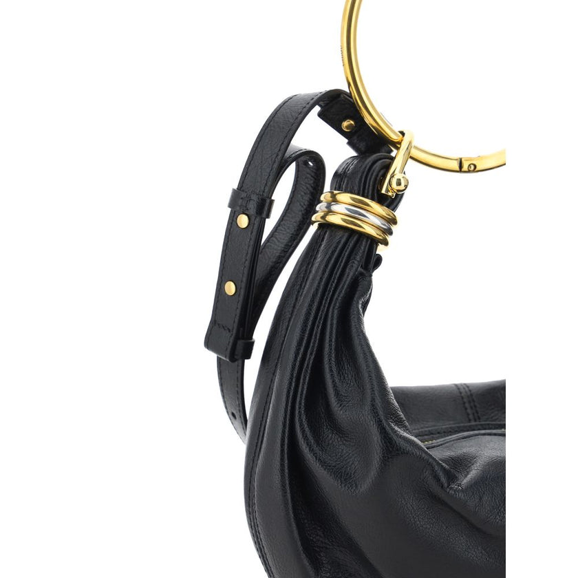 Black Calf Leather Bos Taurus HandbagLeather Bracelet Handbag by Chloé, a round brass handle, an adjustable flat shoulder strap and removable top zipper closure, single interior compartment. Season: AW25 Dimension: 32x32x10 Composition: 100% Calf Leather