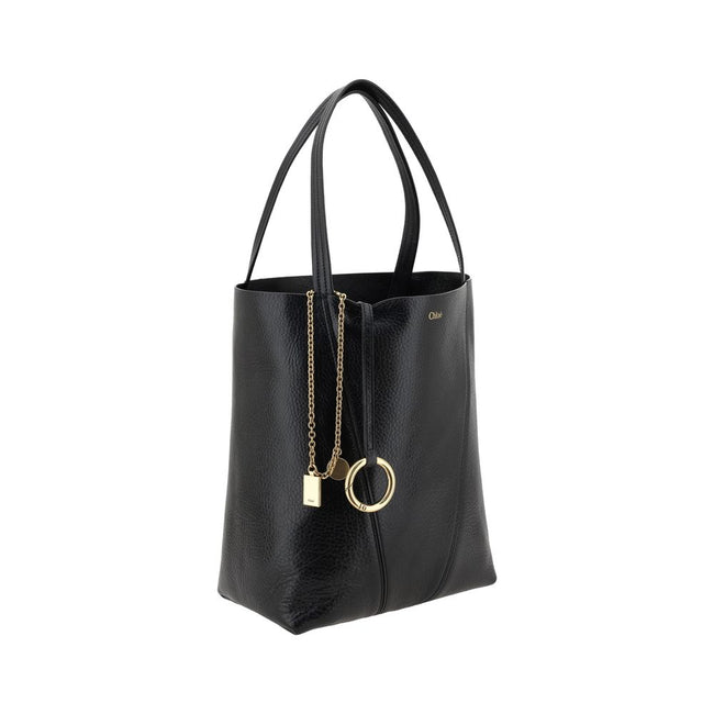 Black Calf Leather Bos Taurus Shoulder BagLeather Spin Shoulder Bag by Chloé is a refined and modern accessory featuring a sleek grained leather design. The two flat top handles offer a comfortable and practical grip, while the brand’s iconic monogram, pr