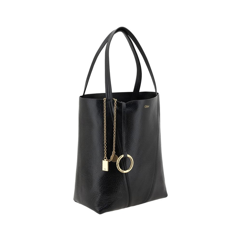 Black Calf Leather Bos Taurus Shoulder BagLeather Spin Shoulder Bag by Chloé is a refined and modern accessory featuring a sleek grained leather design. The two flat top handles offer a comfortable and practical grip, while the brand’s iconic monogram, pr