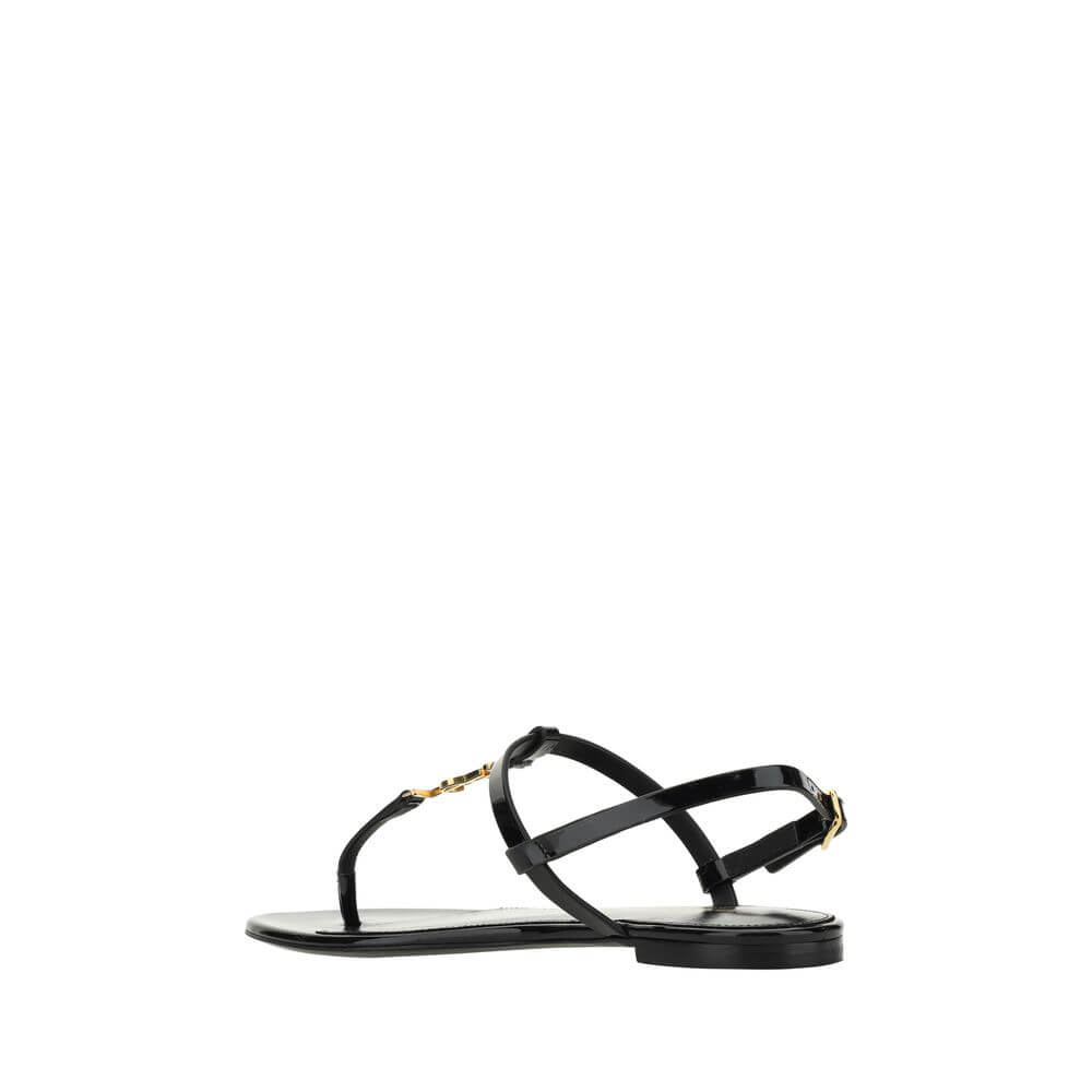 Black Calf Leather Bos Taurus Flat SandalsCalfskin Cassandra Sandals by Saint Laurent, flip-flop style, ankle strap closure with side buckle, iconic brand monogram detail embossed on front, logoed insole. Season: AW25 Composition: UPPER 100% Calf Leather