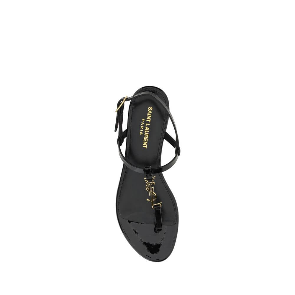 Black Calf Leather Bos Taurus Flat SandalsCalfskin Cassandra Sandals by Saint Laurent, flip-flop style, ankle strap closure with side buckle, iconic brand monogram detail embossed on front, logoed insole. Season: AW25 Composition: UPPER 100% Calf Leather