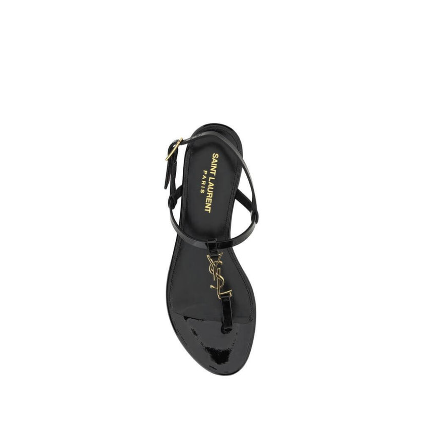 Black Calf Leather Bos Taurus Flat SandalsCalfskin Cassandra Sandals by Saint Laurent, flip-flop style, ankle strap closure with side buckle, iconic brand monogram detail embossed on front, logoed insole. Season: AW25 Composition: UPPER 100% Calf Leather