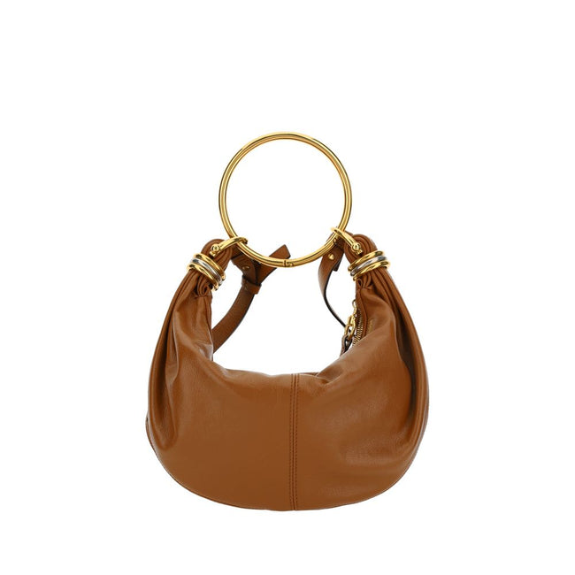 Brown Calf Leather Bos Taurus HandbagLeather Bracelet Handbag by Chloé, a round brass handle, an adjustable flat shoulder strap and removable top zipper closure, single interior compartment. Season: AW25 Dimension: 32x32x10 Composition: 100% Calf Leather
