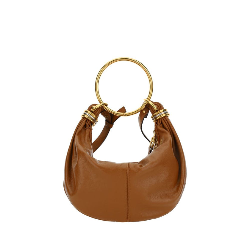 Brown Calf Leather Bos Taurus HandbagLeather Bracelet Handbag by Chloé, a round brass handle, an adjustable flat shoulder strap and removable top zipper closure, single interior compartment. Season: AW25 Dimension: 32x32x10 Composition: 100% Calf Leather