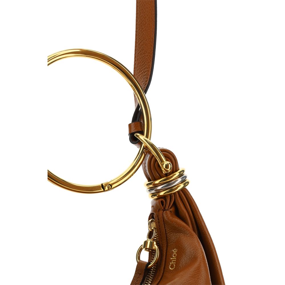 Brown Calf Leather Bos Taurus HandbagLeather Bracelet Handbag by Chloé, a round brass handle, an adjustable flat shoulder strap and removable top zipper closure, single interior compartment. Season: AW25 Dimension: 32x32x10 Composition: 100% Calf Leather