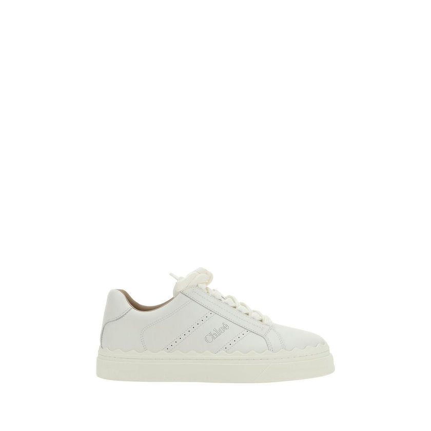White Calf Leather Bos Taurus Low Top SneakersCalfskin Lauren Sneakers by Chloé, featuring lace-up front fastening, round toe, flat sole, perforated detailing on side panels, iconic brand monogram on front tongue and side panels, brand logo print on insol