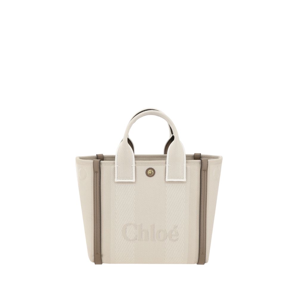 Beige Cotton Shoulder BagChloé’s Carry Tote Bag is a stylish, multifunctional accessory made of cotton with contrasting leather details that accentuate its sophisticated appeal. Magnetic buttons on the side panels allow you to adjust the width of the bag
