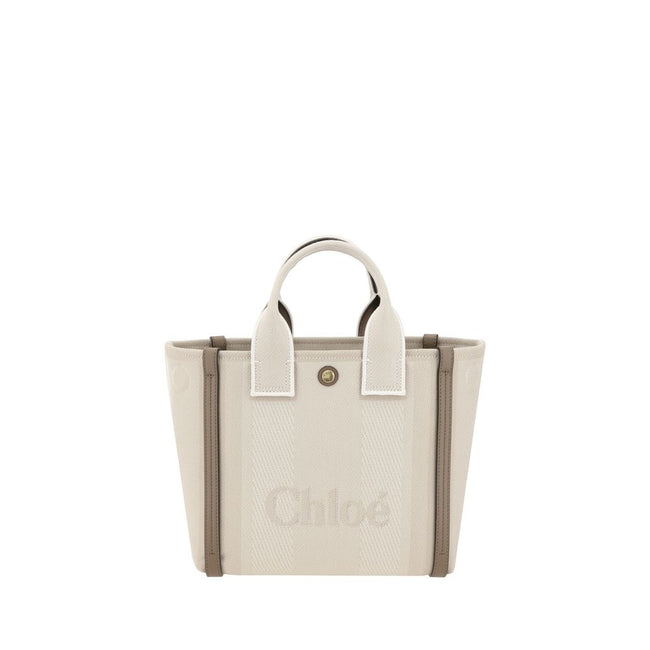 Beige Cotton Shoulder BagChloé’s Carry Tote Bag is a stylish, multifunctional accessory made of cotton with contrasting leather details that accentuate its sophisticated appeal. Magnetic buttons on the side panels allow you to adjust the width of the bag