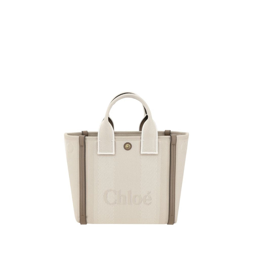 Beige Cotton Shoulder BagChloé’s Carry Tote Bag is a stylish, multifunctional accessory made of cotton with contrasting leather details that accentuate its sophisticated appeal. Magnetic buttons on the side panels allow you to adjust the width of the bag