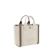 Beige Cotton Shoulder BagChloé’s Carry Tote Bag is a stylish, multifunctional accessory made of cotton with contrasting leather details that accentuate its sophisticated appeal. Magnetic buttons on the side panels allow you to adjust the width of the bag