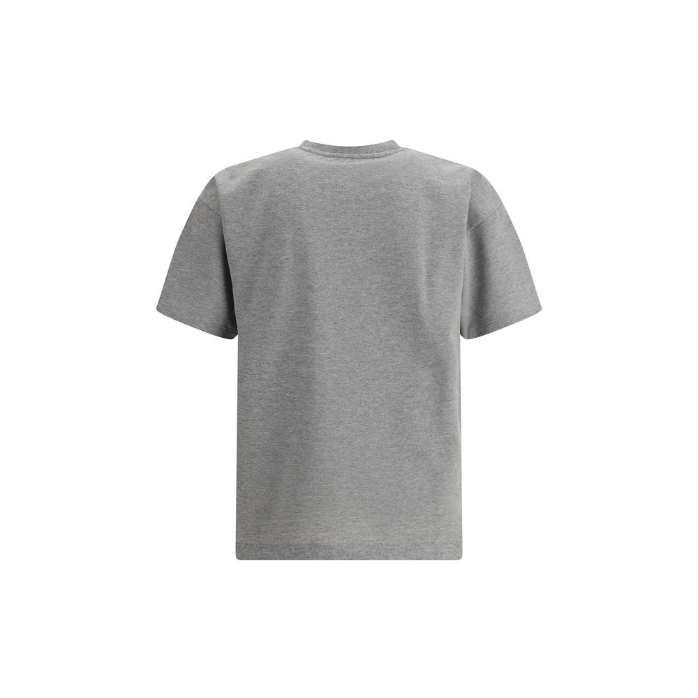 Grey Cotton Oversized T-shirtSaint Laurent’s oversized T-shirt is a casual yet sophisticated piece with a ribbed crew neck for comfort. The brand’s iconic logo, stitched on the front, adds a touch of understated elegance. The mélange pattern gives a sligh