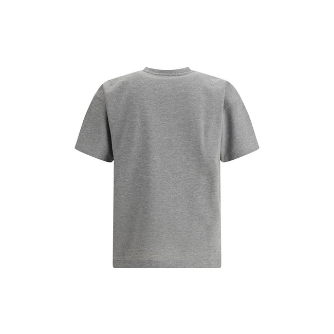 Grey Cotton Oversized T-shirtSaint Laurent’s oversized T-shirt is a casual yet sophisticated piece with a ribbed crew neck for comfort. The brand’s iconic logo, stitched on the front, adds a touch of understated elegance. The mélange pattern gives a sligh