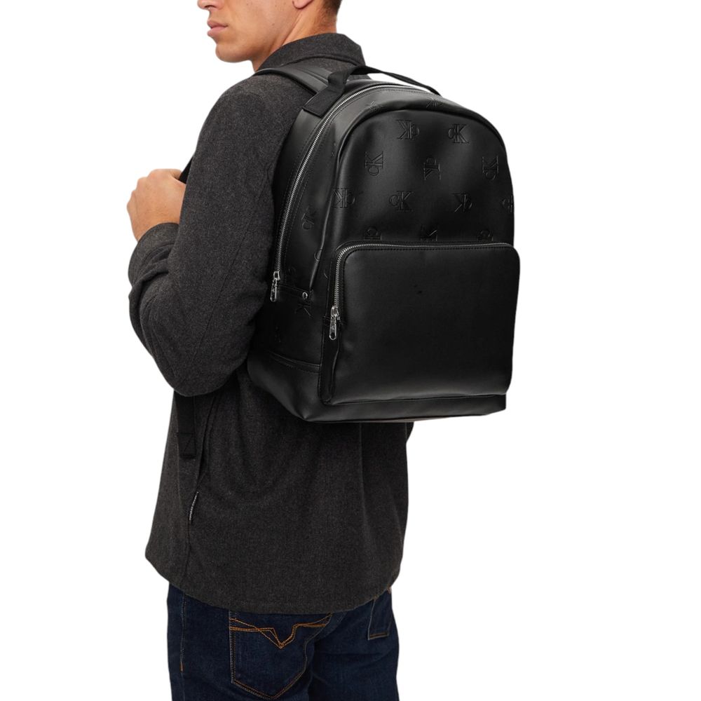 Black Polyethylene BackpackDiscover the AOP CENTER ZIP CAMPUS BP backpack by Calvin Klein Jeans, an essential accessory for the modern man. Made from 100% polyurethane, this backpack offers excellent resistance and durability, perfect for everyday use. It