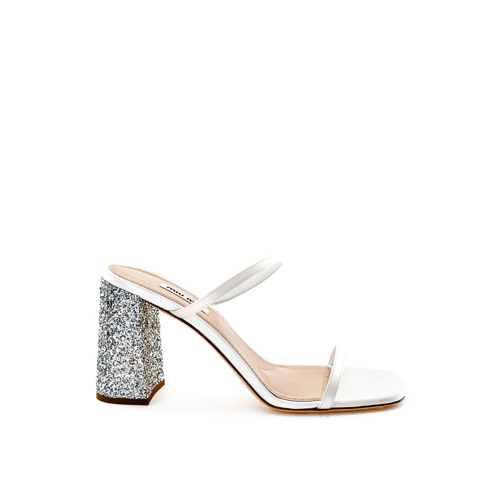 White Silk SandalMiu Miu Mixed Silk Sandal with Crystals Heel. White, square toe, open front, silk micro strap on front, silk edged, glitter covered block heel. Composition: 100% Leather-Sku inside:24GIU42White Silk Sandal${tagsMiu MiuAulae White Silk San