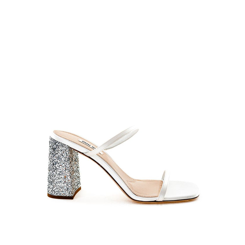 White Silk SandalMiu Miu Mixed Silk Sandal with Crystals Heel. White, square toe, open front, silk micro strap on front, silk edged, glitter covered block heel. Composition: 100% Leather-Sku inside:24GIU42White Silk Sandal${tagsMiu MiuAulae White Silk San