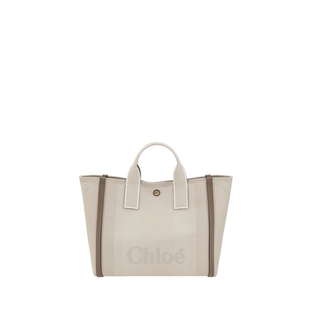 Beige Cotton HandbagChloé’s Carry Handbag is a refined and versatile accessory made of cotton with contrasting leather details that accentuate its elegance. The snap top closure provides practicality, while the double flat handles and leather extension on