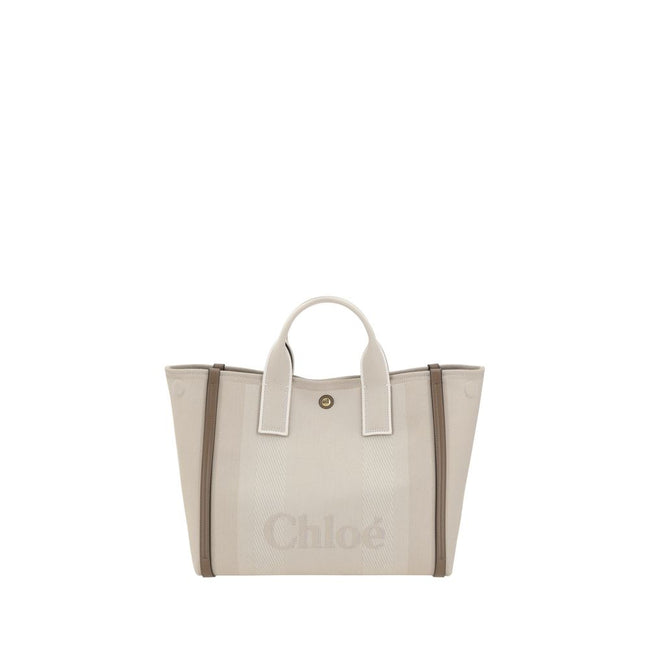 Beige Cotton HandbagChloé’s Carry Handbag is a refined and versatile accessory made of cotton with contrasting leather details that accentuate its elegance. The snap top closure provides practicality, while the double flat handles and leather extension on
