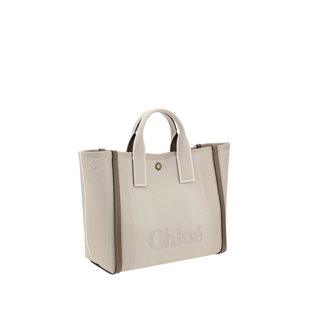 Beige Cotton HandbagChloé’s Carry Handbag is a refined and versatile accessory made of cotton with contrasting leather details that accentuate its elegance. The snap top closure provides practicality, while the double flat handles and leather extension on