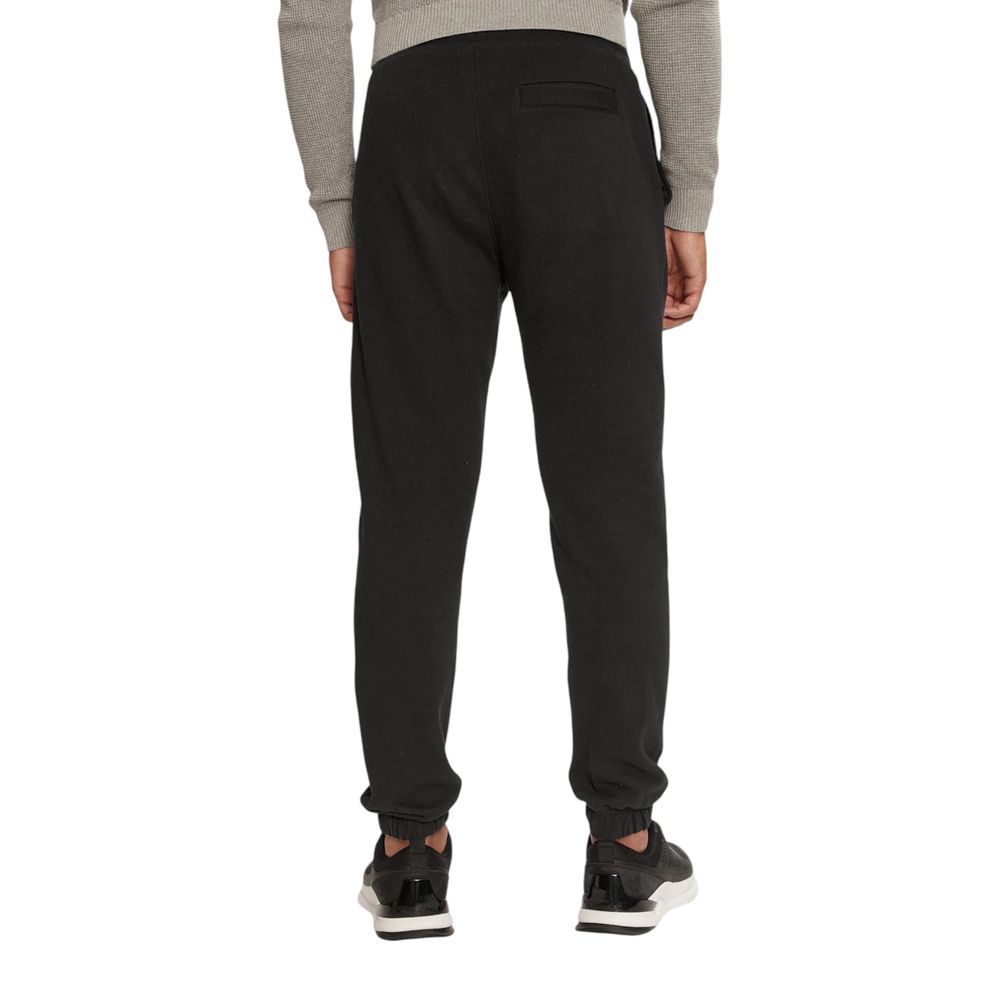 Black Organic Cotton Joggers Workout PantThe Calvin Klein Jeans CHENILLE MONOLOGO SW J30J326685 men’s sweatpants are made from 100% organic cotton, ensuring exceptional comfort and a soft feel against the skin. These pants are perfect for daily activities