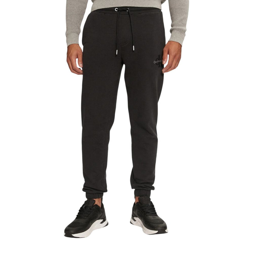 Black Organic Cotton Joggers Workout PantThe Calvin Klein Jeans CHENILLE MONOLOGO SW J30J326685 men’s sweatpants are made from 100% organic cotton, ensuring exceptional comfort and a soft feel against the skin. These pants are perfect for daily activities