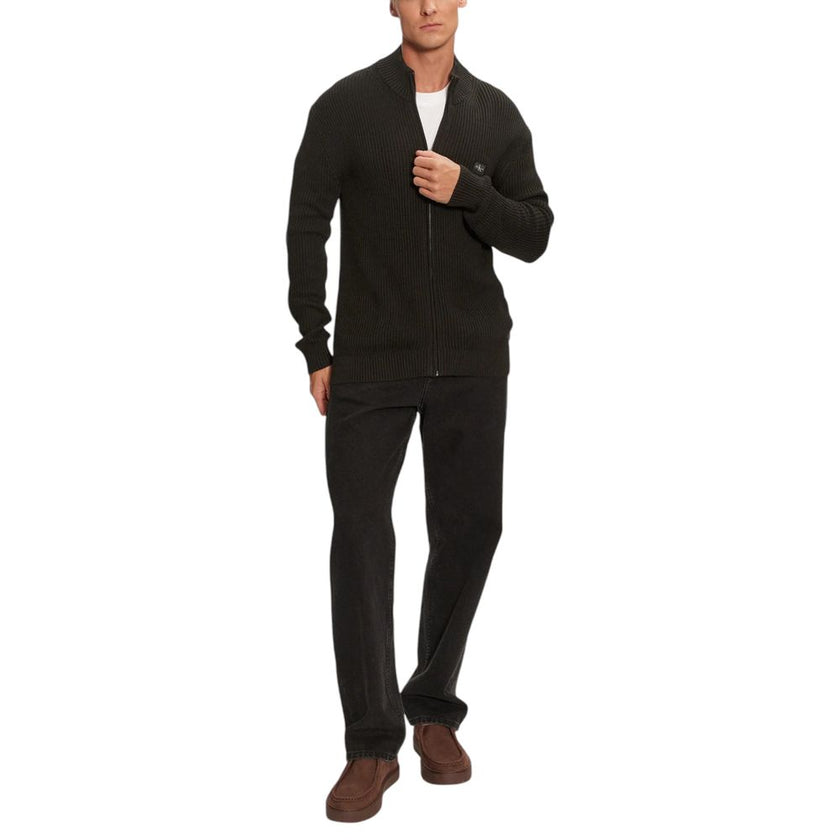 Black Cotton CardiganDiscover the Calvin Klein Jeans WOVEN LABEL ZIP THRO cardigan for men, an essential piece for your wardrobe. Made from 100% cotton, this cardigan offers exceptional comfort and a perfect fit. The ribbed design adds a touch of casual e