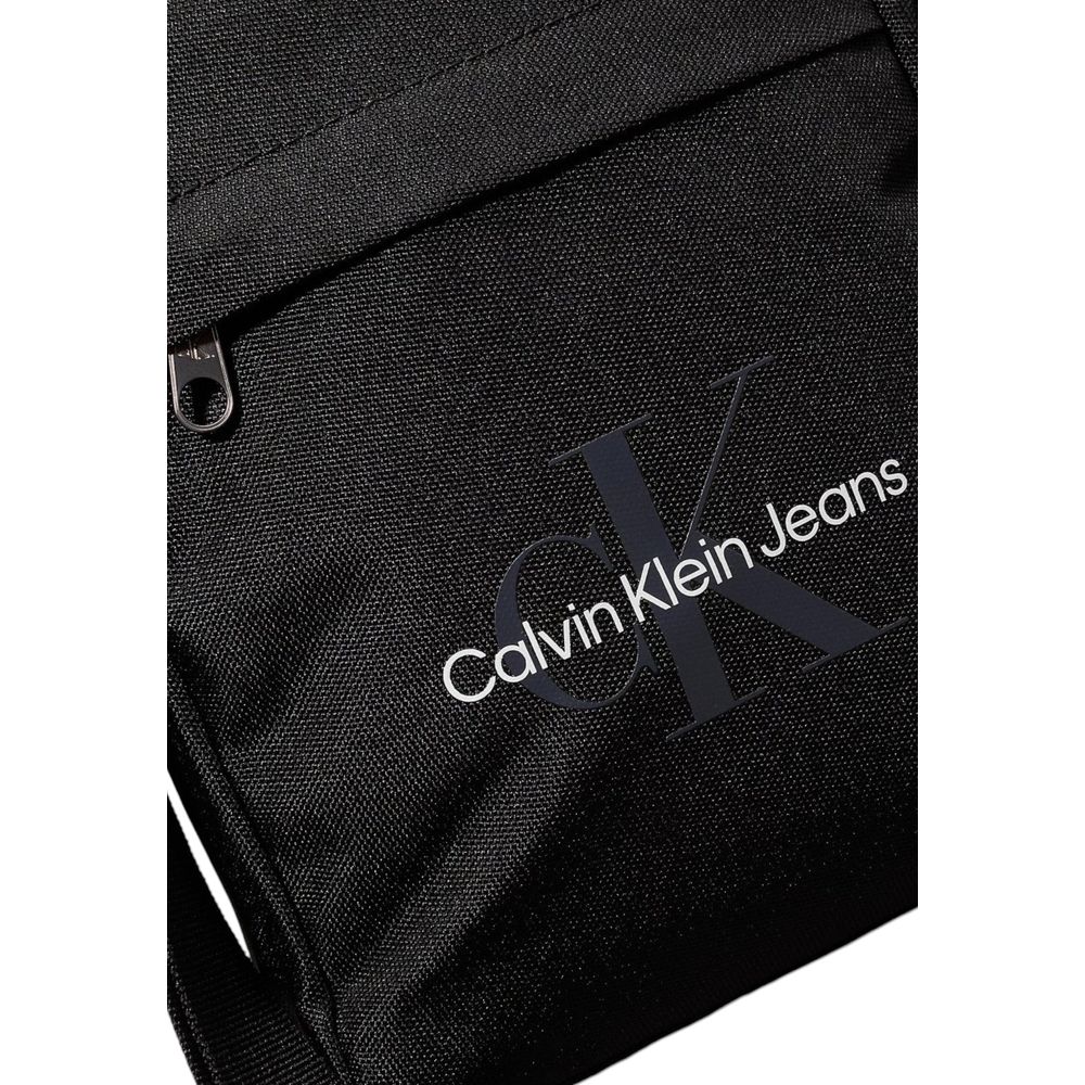 Black Recycled Polyester Messenger BagThe Calvin Klein SPORT ESSENTIALS REPORTER18 M K50K512011 men’s crossbody bag is the perfect accessory for those seeking practicality and style. Made from 100% recycled polyester, this bag is not only sustainable but