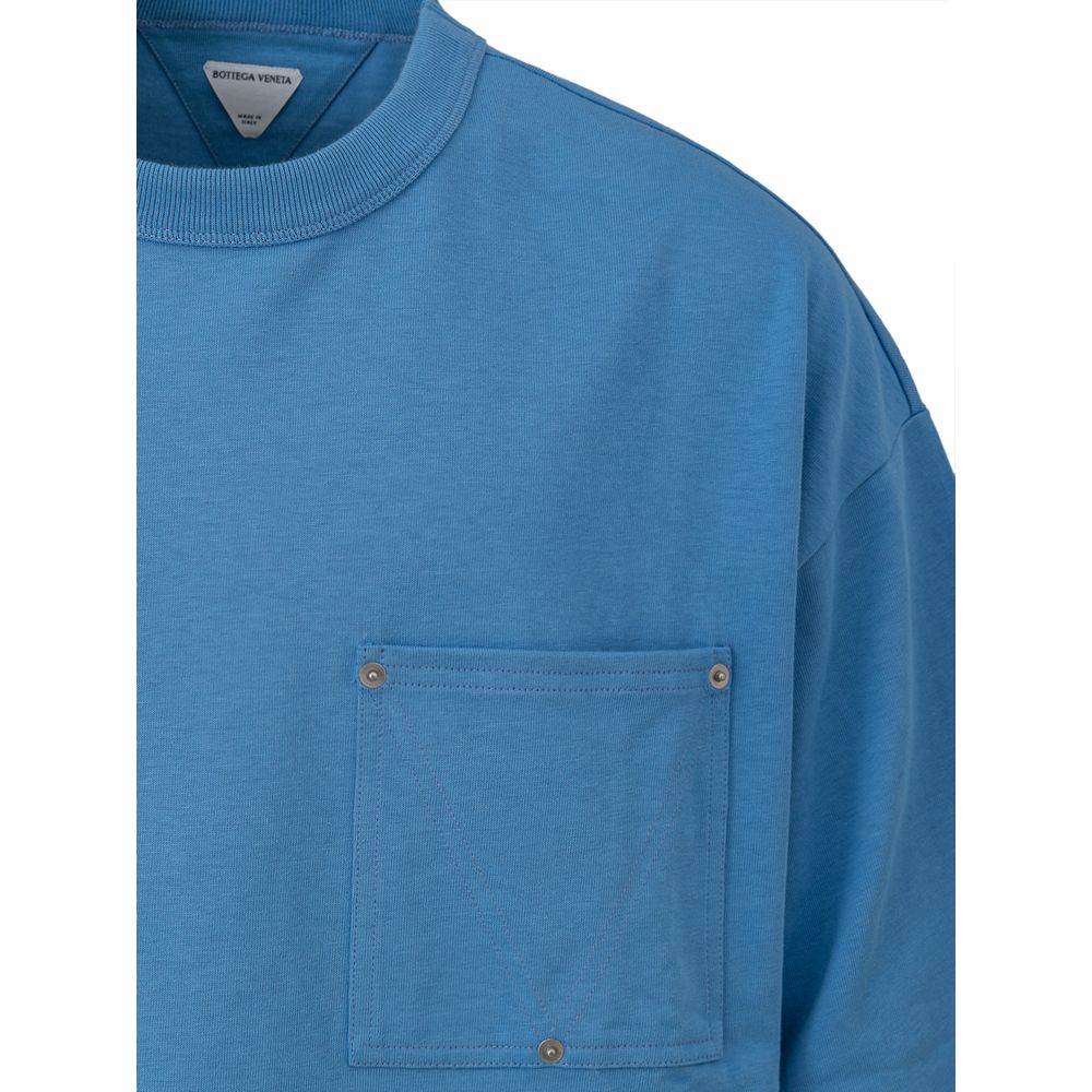 Blue Cotton T-ShirtBottega Veneta oversized cotton jersey T-shirt Materials: cotton jersey Size and fit: oversize Neckline: Crew neck Shoulders: relaxed Sleeves: short Pockets: studded patch pocket Bottom: With ribbed edges, With straight hemline Made In