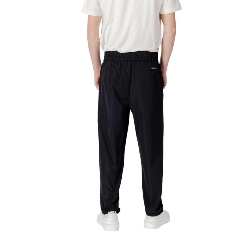 Black Polyester Casual PantsDiscover unparalleled comfort with the Calvin Klein Jeans TRACK PANT regular/comfort pants for men. Made from 100% polyester, these pants offer a comfortable and versatile fit, perfect for your everyday activities. The modern d