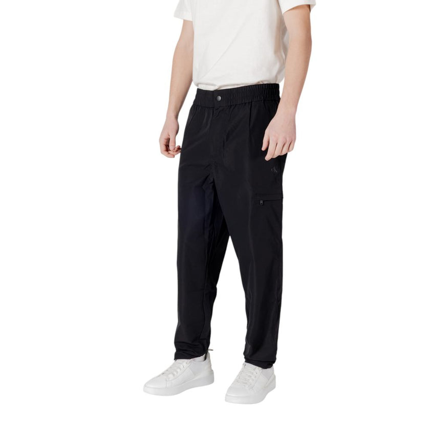 Black Polyester Casual PantsDiscover unparalleled comfort with the Calvin Klein Jeans TRACK PANT regular/comfort pants for men. Made from 100% polyester, these pants offer a comfortable and versatile fit, perfect for your everyday activities. The modern d