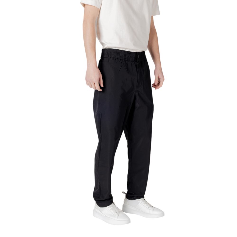 Black Polyester Casual PantsDiscover unparalleled comfort with the Calvin Klein Jeans TRACK PANT regular/comfort pants for men. Made from 100% polyester, these pants offer a comfortable and versatile fit, perfect for your everyday activities. The modern d