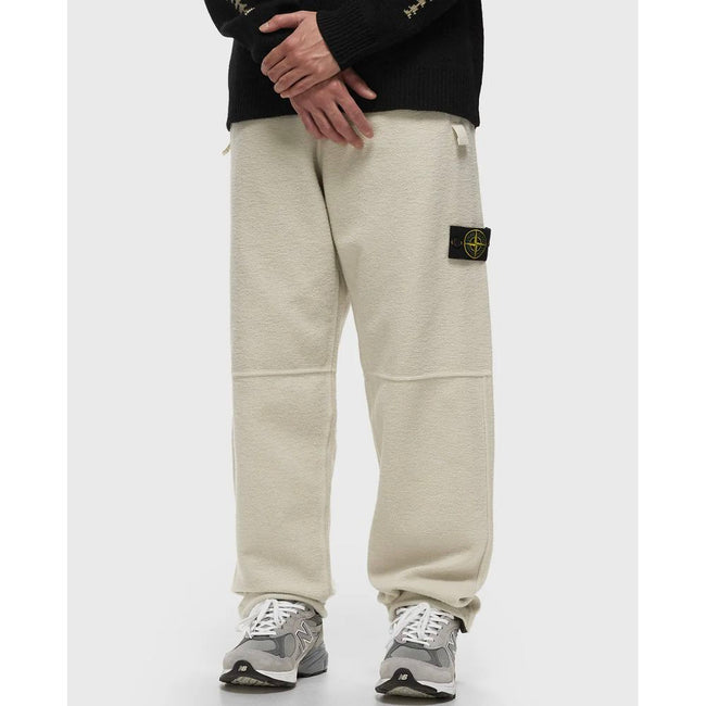 White Cotton Men's TrouserElevate your casualwear repertoire with these impeccably crafted trousers from Stone Island. A fusion of comfort and high-end style, they boast a creamy white hue in sumptuous cotton fleece. Designed with meticulous attention to