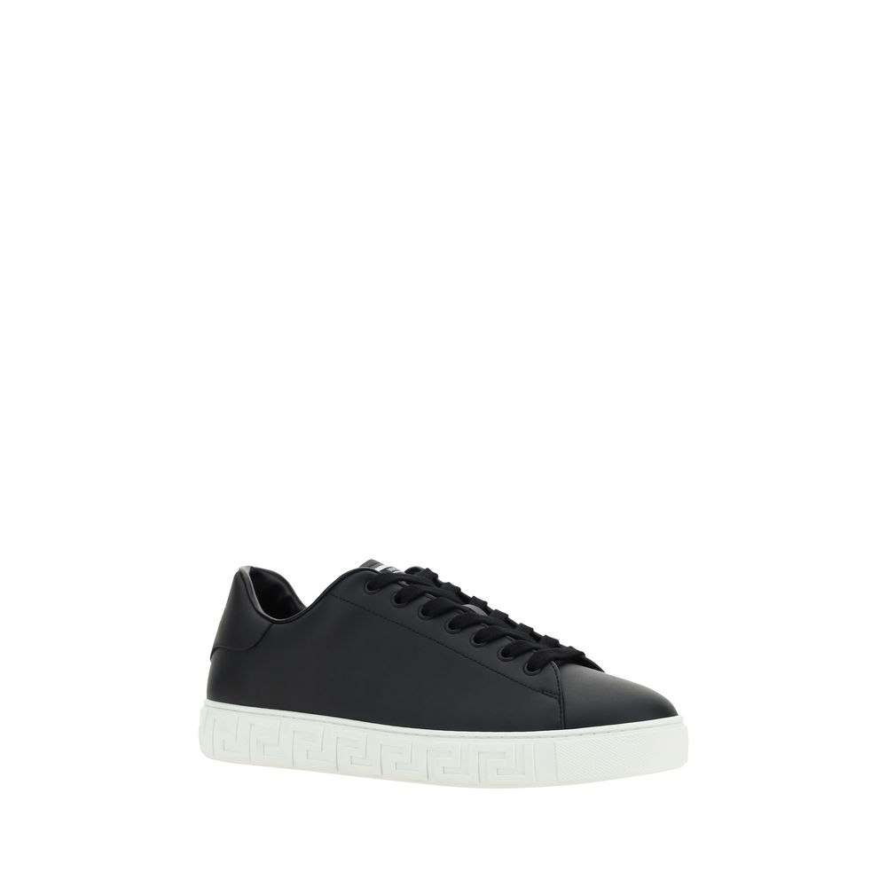 Black Rubber Low Top SneakersCalfskin Sneakers by Versace, featuring round toe, front lace-up closure, flat sole with iconic Greek embossed print, iconic monogram stamped press-stamped on back, press-stamped logo insole. Season: AW25 Composition: SOLE 100