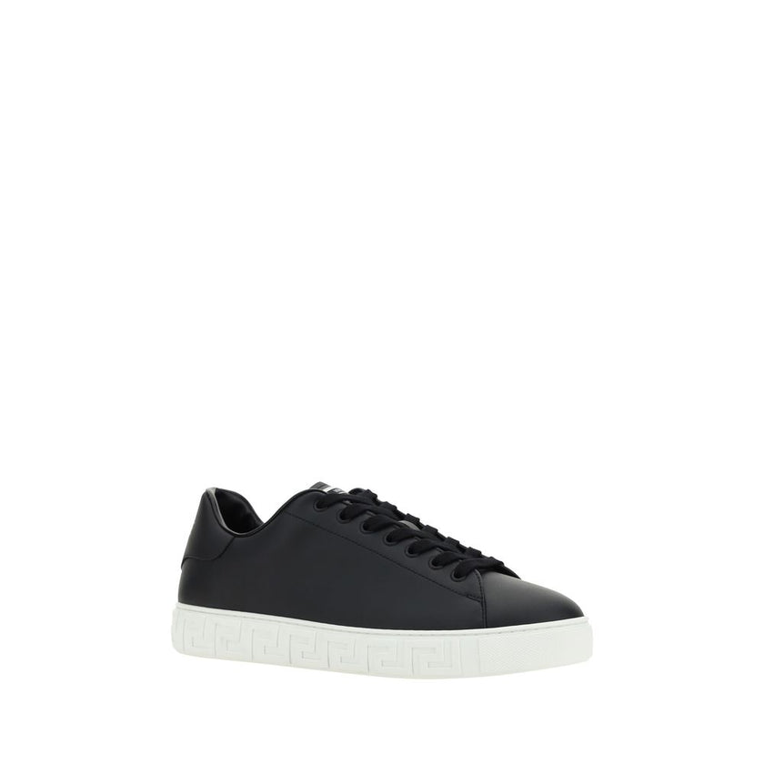 Black Rubber Low Top SneakersCalfskin Sneakers by Versace, featuring round toe, front lace-up closure, flat sole with iconic Greek embossed print, iconic monogram stamped press-stamped on back, press-stamped logo insole. Season: AW25 Composition: SOLE 100