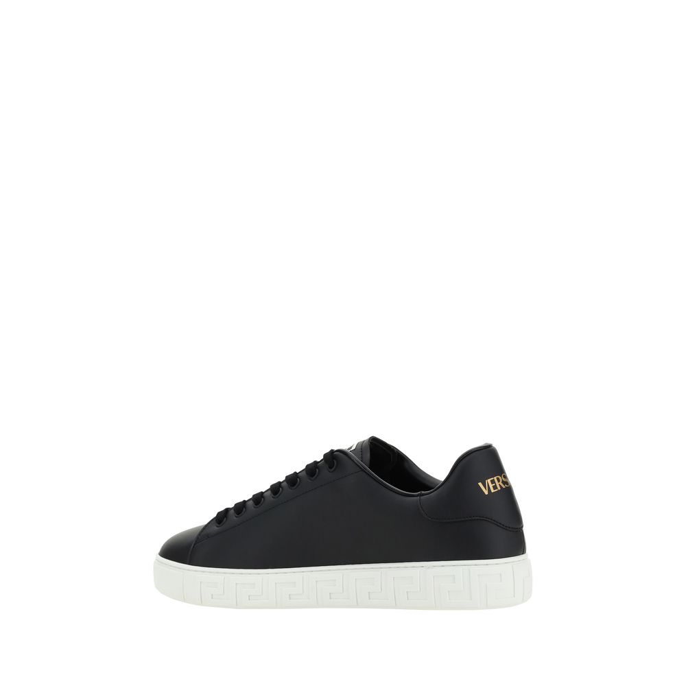 Black Rubber Low Top SneakersCalfskin Sneakers by Versace, featuring round toe, front lace-up closure, flat sole with iconic Greek embossed print, iconic monogram stamped press-stamped on back, press-stamped logo insole. Season: AW25 Composition: SOLE 100