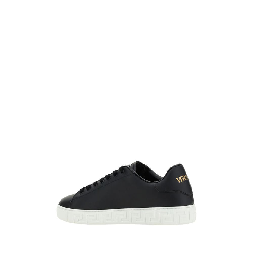 Black Rubber Low Top SneakersCalfskin Sneakers by Versace, featuring round toe, front lace-up closure, flat sole with iconic Greek embossed print, iconic monogram stamped press-stamped on back, press-stamped logo insole. Season: AW25 Composition: SOLE 100