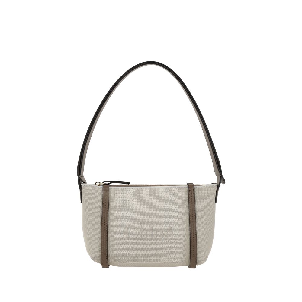 Beige Cotton Shoulder BagChloé’s cotton Carry Shoulder Bag is a stylish and versatile accessory made from durable cotton. It features a flat leather shoulder strap that is comfortable for carrying on the shoulder. The closure features a top zipper, provid
