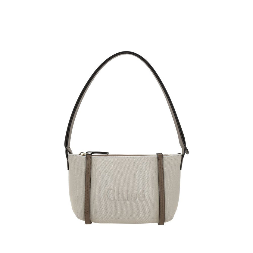 Beige Cotton Shoulder BagChloé’s cotton Carry Shoulder Bag is a stylish and versatile accessory made from durable cotton. It features a flat leather shoulder strap that is comfortable for carrying on the shoulder. The closure features a top zipper, provid