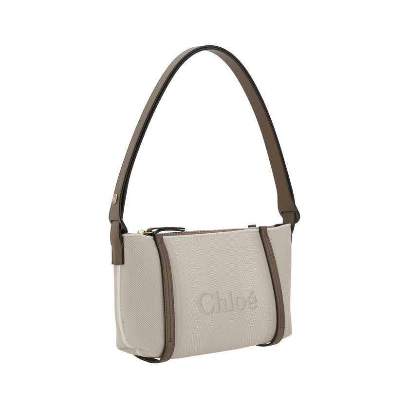 Beige Cotton Shoulder BagChloé’s cotton Carry Shoulder Bag is a stylish and versatile accessory made from durable cotton. It features a flat leather shoulder strap that is comfortable for carrying on the shoulder. The closure features a top zipper, provid