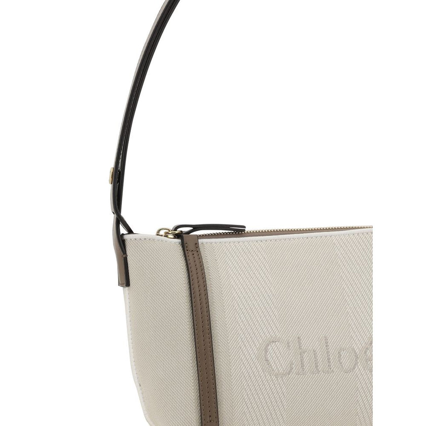Beige Cotton Shoulder BagChloé’s cotton Carry Shoulder Bag is a stylish and versatile accessory made from durable cotton. It features a flat leather shoulder strap that is comfortable for carrying on the shoulder. The closure features a top zipper, provid