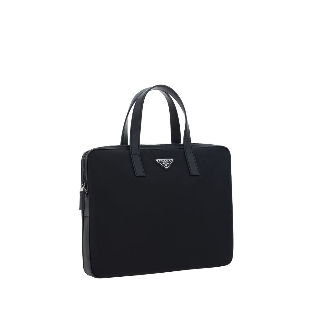 Black Polyamide Shoulder BagRe-Nylon Work Shoulder Bag by Prada, top closure by a double-slider round zipper, double flat leather handles, adjustable and removable webing shoulder strap, iconic enameled triangular brand logo plaque applied to front, inter
