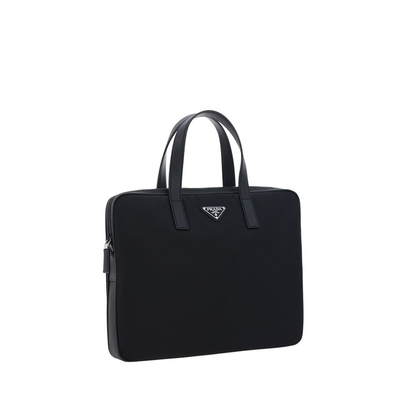 Black Polyamide Shoulder BagRe-Nylon Work Shoulder Bag by Prada, top closure by a double-slider round zipper, double flat leather handles, adjustable and removable webing shoulder strap, iconic enameled triangular brand logo plaque applied to front, inter