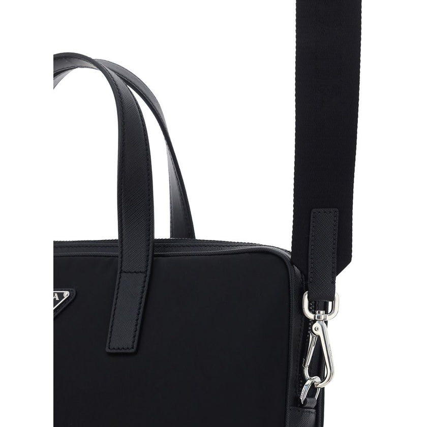 Black Polyamide Shoulder BagRe-Nylon Work Shoulder Bag by Prada, top closure by a double-slider round zipper, double flat leather handles, adjustable and removable webing shoulder strap, iconic enameled triangular brand logo plaque applied to front, inter
