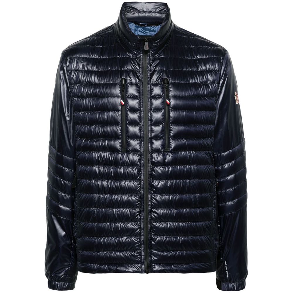 Blue Polyamide Men JacketElevate your outerwear with the Moncler Grenoble jacket, a fusion of luxe and practicality. This high-necked piece, crafted for the fashion-forward, flaunts a padded silhouette with a front zipper closure that adds an edge to any