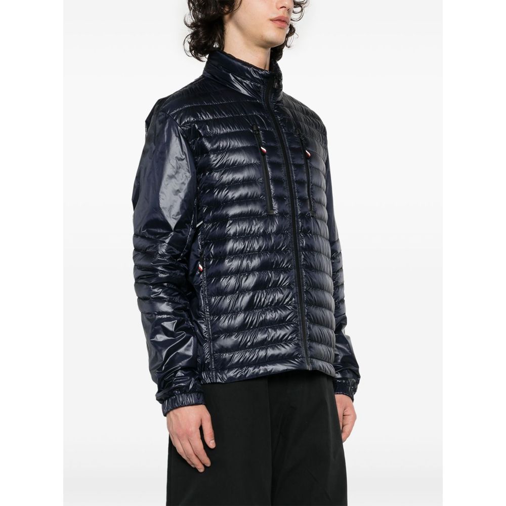 Blue Polyamide Men JacketElevate your outerwear with the Moncler Grenoble jacket, a fusion of luxe and practicality. This high-necked piece, crafted for the fashion-forward, flaunts a padded silhouette with a front zipper closure that adds an edge to any