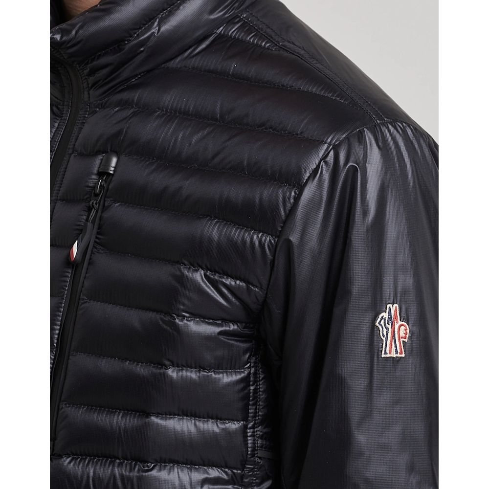 Black Polyamide Men JacketElevate your outerwear collection with the ultrachic Moncler Grenoble jacket. Engineered for both style and warmth, this sophisticated high-necked jacket features a sleek front zipper closure that seamlessly leads into its plush,