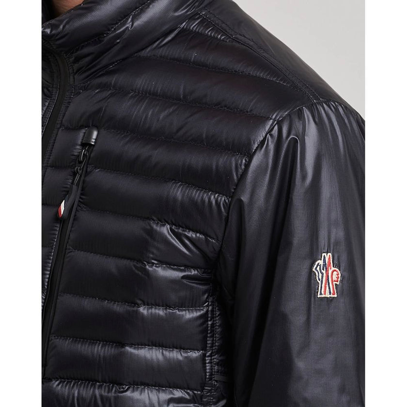 Black Polyamide Men JacketElevate your outerwear collection with the ultrachic Moncler Grenoble jacket. Engineered for both style and warmth, this sophisticated high-necked jacket features a sleek front zipper closure that seamlessly leads into its plush,