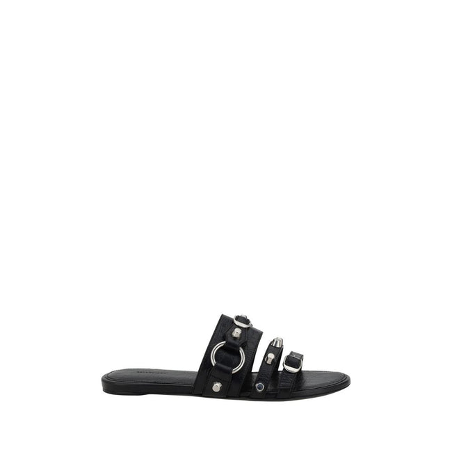 Black Calf Leather Bos Taurus Flat SandalsBalenciaga’s studded Sandals combine a bold and sophisticated design. A slip-on model with a flat sole, they feature three front straps decorated with silver studs and rings, giving them a modern, rock look. These