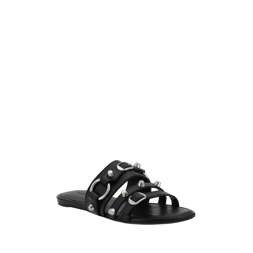 Black Calf Leather Bos Taurus Flat SandalsBalenciaga’s studded Sandals combine a bold and sophisticated design. A slip-on model with a flat sole, they feature three front straps decorated with silver studs and rings, giving them a modern, rock look. These