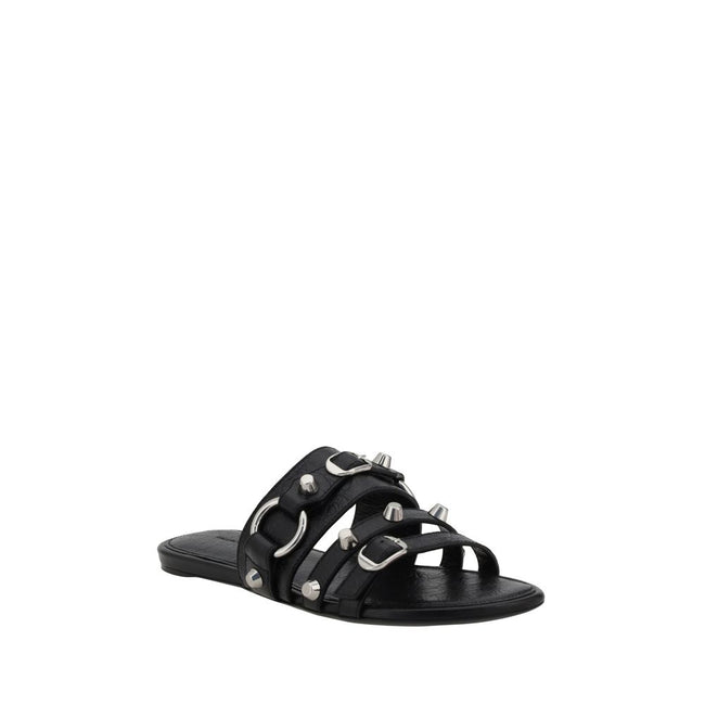Black Calf Leather Bos Taurus Flat SandalsBalenciaga’s studded Sandals combine a bold and sophisticated design. A slip-on model with a flat sole, they feature three front straps decorated with silver studs and rings, giving them a modern, rock look. These
